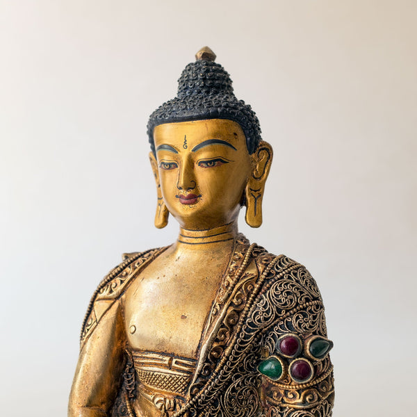 Amitabha Buddha Statue made of copper, lost wax casting, silver and gold plated, set with filigree and set synthetic gemstones in ruby red, emerald green, lapis lazuli blue. The face is set in gold. Handmade in Nepal
