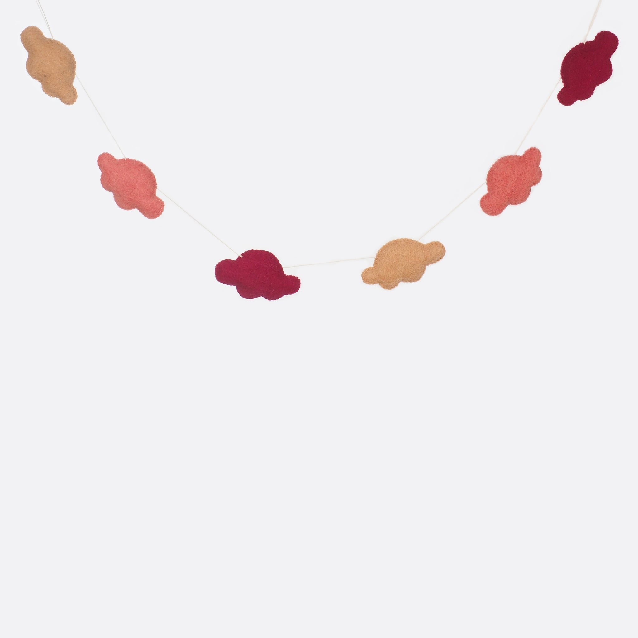 A garland with six small clouds. Three different shades of rose are used for the clouds. Two clouds have always the same color. 
