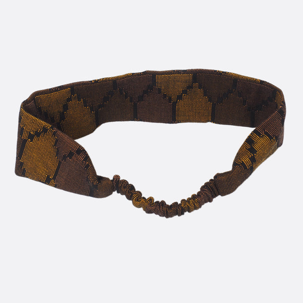 Back view of the dark blue Battiayo headband. The small scrunchy part, which gives the headband the elasticity is shown. The elastic part is covered with the dhaka fabric.