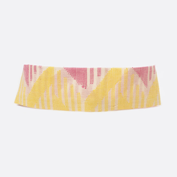 Front view of the Pink & Yellow  headband when it is turned around..  The background is white. 