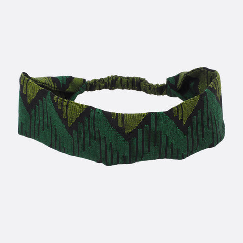 Top view of the Battiayo Forest Green headband. The handwoven traditional dhaka fabric is dark green, light green and black.The dhaka fabric has a geometric pattern and is handwoven by amazing women. The pattern has lines in different length and thickness.