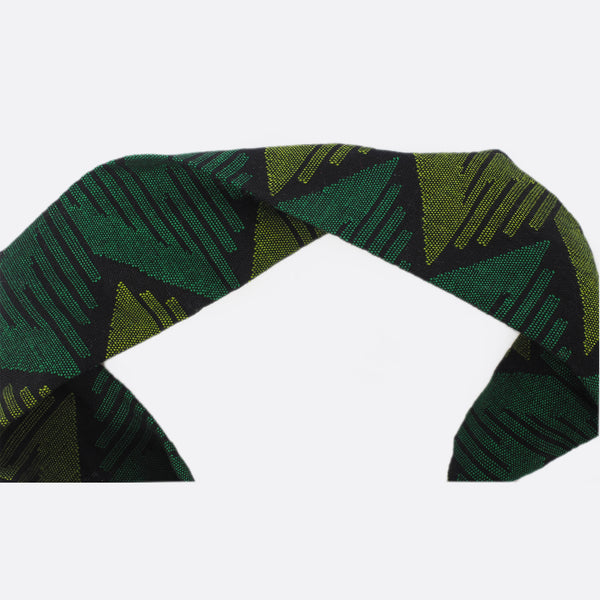 Headband is half turned around to show that each side is a bit different. On one side the dominant color is the light green. On the other side the dominant color is the dark green.