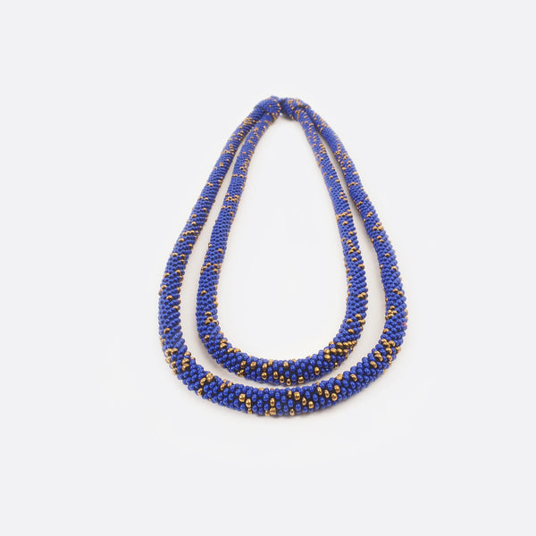 Close up of the handmade Battiayo necklace. One string is a bit shorter than the other string.