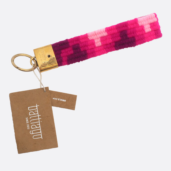 handwoven key chain with handmade brass buckle; key chain has 4 different shades of pink