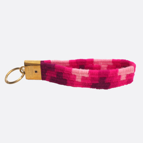 handwoven key chain with handmade brass buckle; key chain has 4 different shades of pink