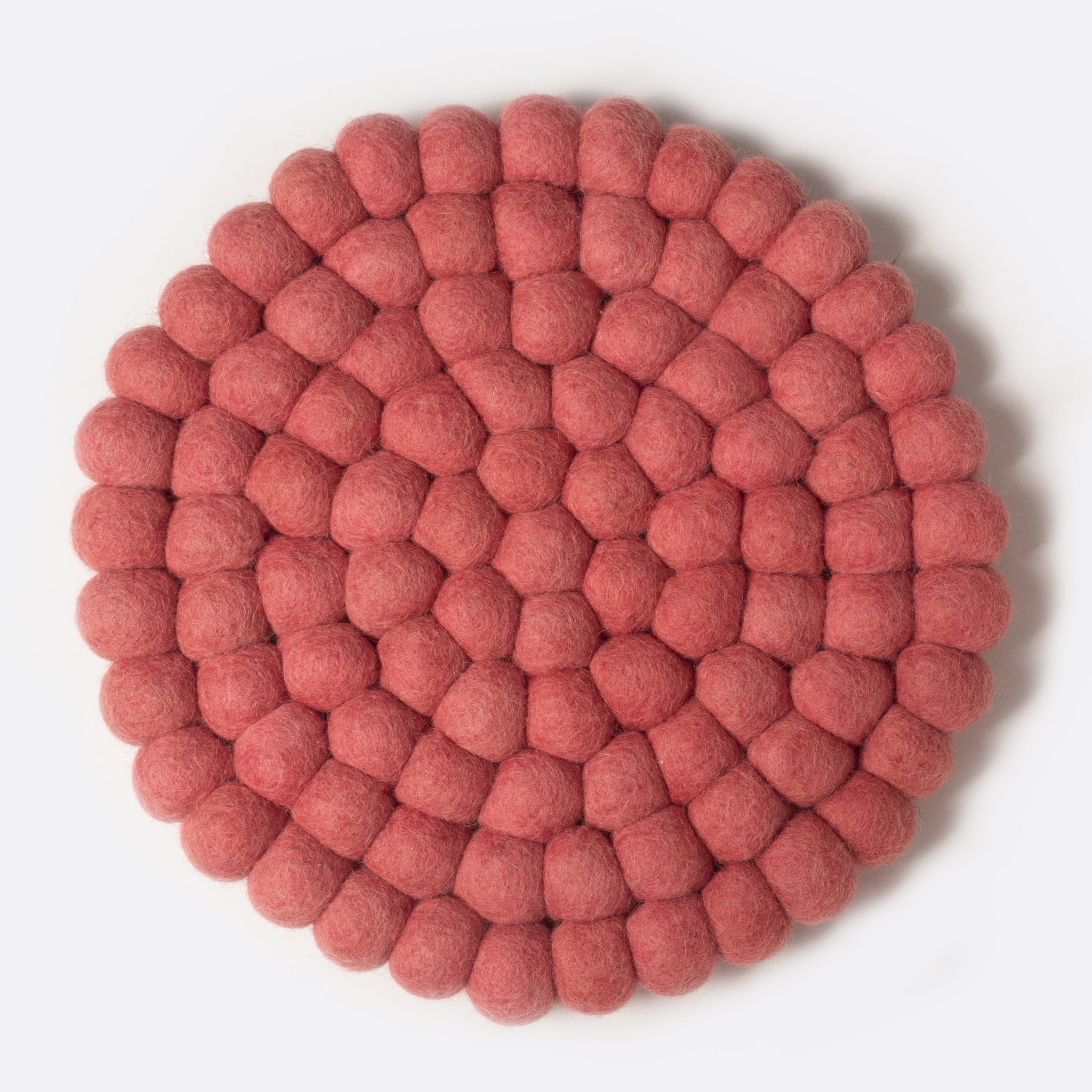 Round felt coaster which is made from little felt balls. The color is rose.