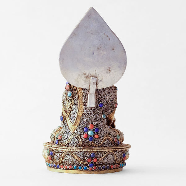 Bhaisajyaguru statue, body from copper, lost wax casting, decorated with fine filigree, gold and silver plated, set with turquoise, coral and lapis lazuli. Backside view. Handmade in Nepal