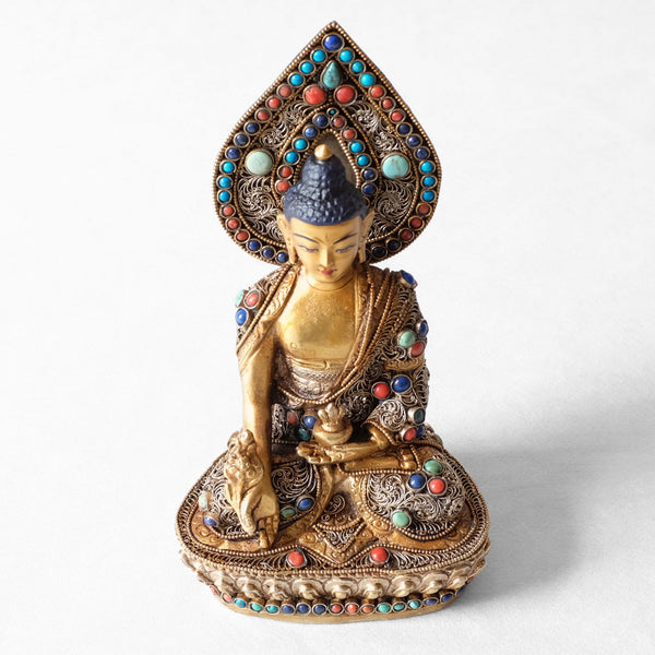 Bhaisajyaguru statue, body from copper, lost wax casting, decorated with fine filigree, gold and silver plated, set with turquoise, coral and lapis lazuli. The face is set in gold. Handmade by Dragon Craft, Nepal