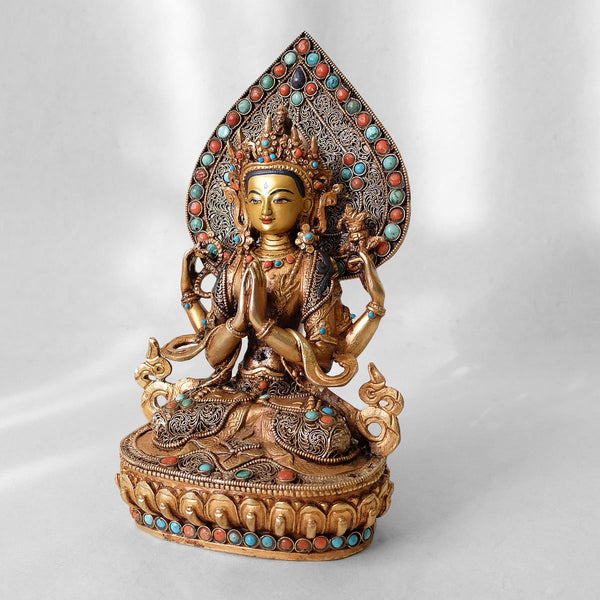 Chenrezig (Avalokiteshvara) statue, body from copper, lost wax casting, decorated with fine filigree, gold and silver plated, set with turquoise, coral and lapis lazuli. The face is set in gold. Handmade in Nepal