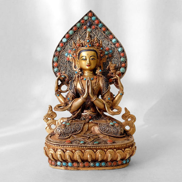 Chenrezig (Avalokiteshvara) statue, body from copper, lost wax casting, decorated with fine filigree, gold and silver plated, set with turquoise, coral and lapis lazuli. The face is set in gold. Handmade in Nepal