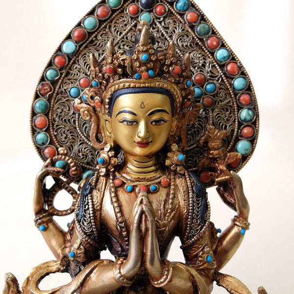 Chenrezig (Avalokiteshvara) statue, body from copper, lost wax casting, decorated with fine filigree, gold and silver plated, set with turquoise, coral and lapis lazuli. The face is set in gold. Handmade in Nepal