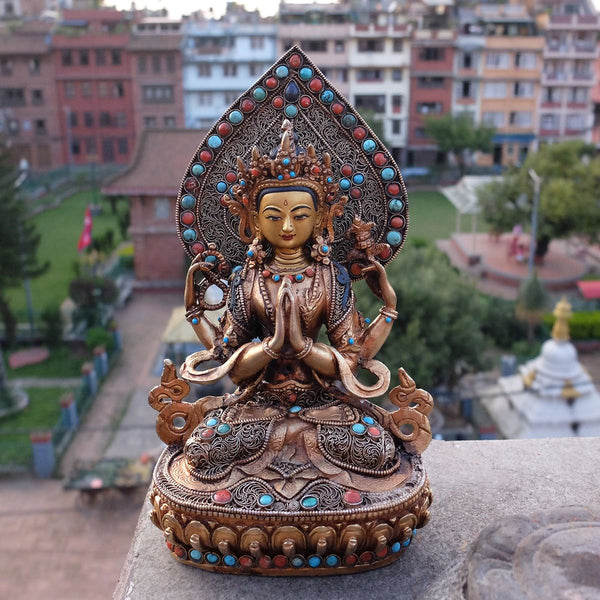 Chenrezig (Avalokiteshvara) statue, body from copper, lost wax casting, decorated with fine filigree, gold and silver plated, set with turquoise, coral and lapis lazuli. The face is set in gold. Handmade in Nepal.