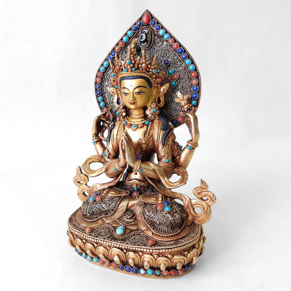 Chenrezig (Avalokiteshvara) statue, body from copper, lost wax casting, decorated with fine filigree, gold and silver plated, set with turquoise, coral and lapis lazuli. The face is set in gold. Handmade in Nepal