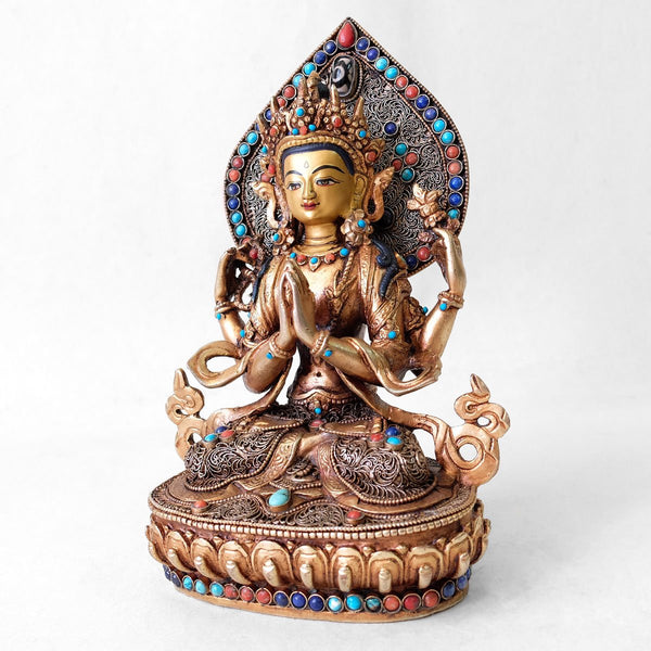 Chenrezig (Avalokiteshvara) statue, body from copper, lost wax casting, decorated with fine filigree, gold and silver plated, set with turquoise, coral and lapis lazuli. The face is set in gold. Handmade in Nepal