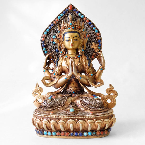 Chenrezig (Avalokiteshvara) statue, body from copper, lost wax casting, decorated with fine filigree, gold and silver plated, set with turquoise, coral and lapis lazuli. The face is set in gold. Handmade in Nepal