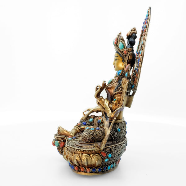 Green Tara statue, body from copper, lost wax casting, decorated with fine filigree, gold and silver plated, set with turquoise, coral and lapis lazuli. The face is set in gold. Handmade in Nepal