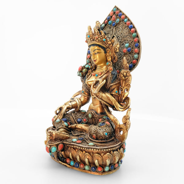 Green Tara statue, body from copper, lost wax casting, decorated with fine filigree, gold and silver plated, set with turquoise, coral and lapis lazuli. The face is set in gold. Handmade in Nepal