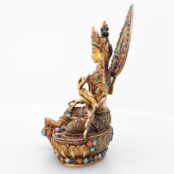 Green Tara statue, body from copper, lost wax casting, decorated with fine filigree, gold and silver plated, set with turquoise, coral and lapis lazuli. The face is set in gold. Handmade in Nepal