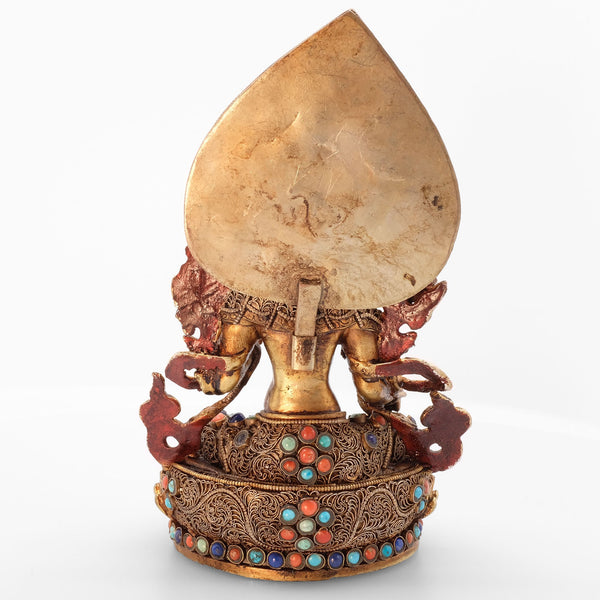 Green Tara statue, body from copper, lost wax casting, decorated with fine filigree, gold and silver plated, set with turquoise, coral and lapis lazuli. Backside view. Handmade in Nepal.