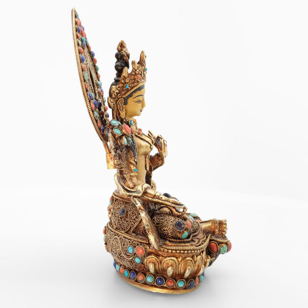 Green Tara statue, body from copper, lost wax casting, decorated with fine filigree, gold and silver plated, set with turquoise, coral and lapis lazuli. The face is set in gold. Handmade in Nepal.