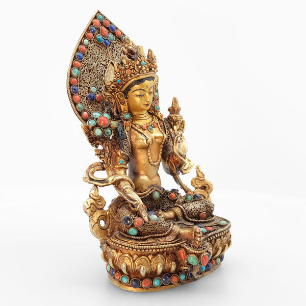 Green Tara statue, body from copper, lost wax casting, decorated with fine filigree, gold and silver plated, set with turquoise, coral and lapis lazuli. The face is set in gold. Handmade in Nepal.