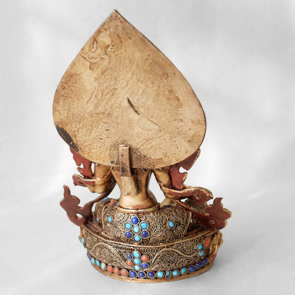 Green Tara statue, body from copper, lost wax casting, decorated with fine filigree, gold and silver plated, set with turquoise, coral and lapis lazuli. Backside view. Handmade in Nepal.