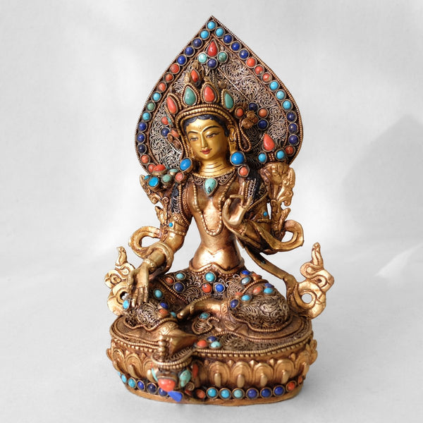 Green Tara statue, body from copper, lost wax casting, decorated with fine filigree, gold and silver plated, set with turquoise, coral and lapis lazuli. The face is set in gold. Handmade in Nepal