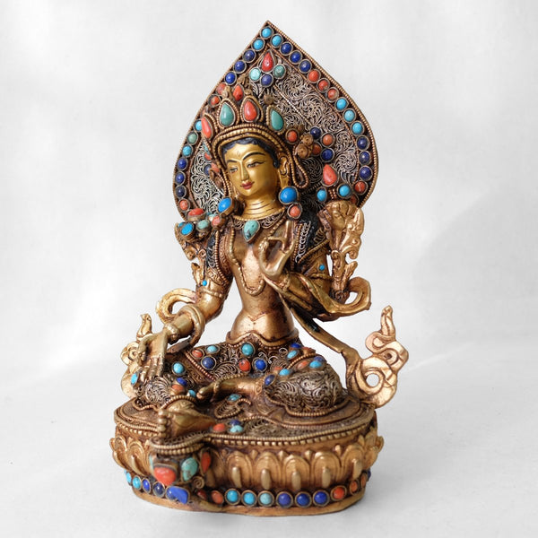 Green Tara statue, body from copper, lost wax casting, decorated with fine filigree, gold and silver plated, set with turquoise, coral and lapis lazuli. The face is set in gold. Handmade in Nepal.