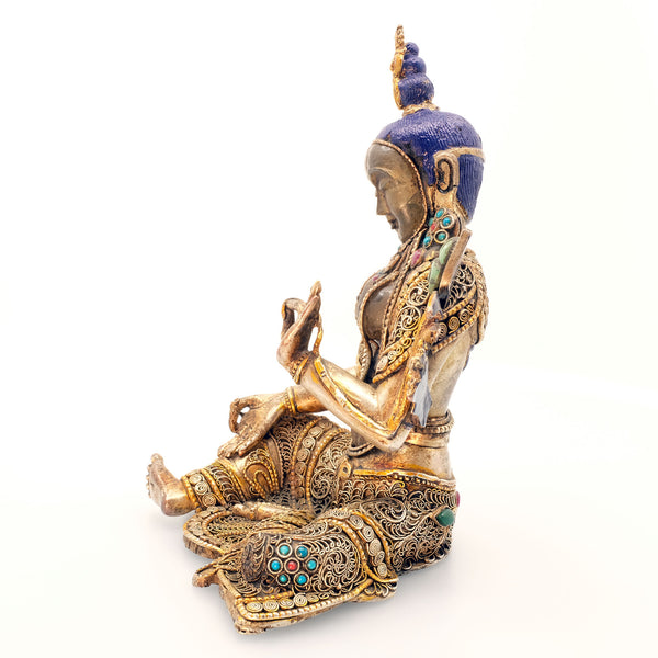 Green Tara, face and body carved from crystal, copper set with filigree, silver plated, gold plated set with turquoise and coral coloured stones. Side view