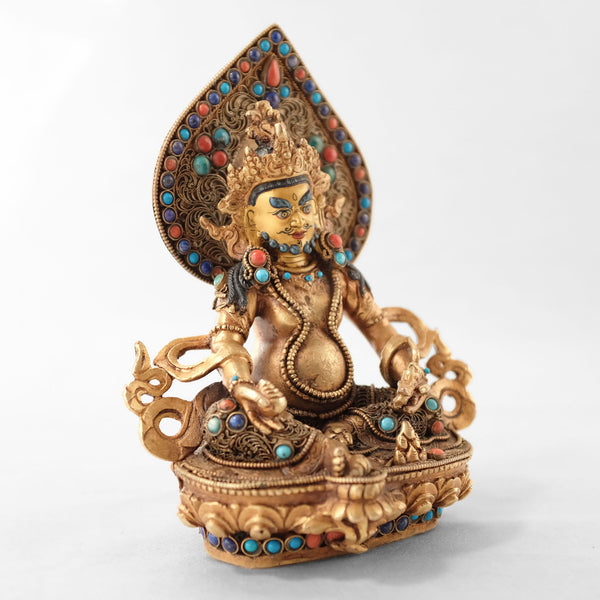 Jambhala statue, body from copper, lost wax casting, decorated with fine filigree, gold and silver plated, set with turquoise, coral and lapis lazuli. The face is set in gold. Handmade in Nepal