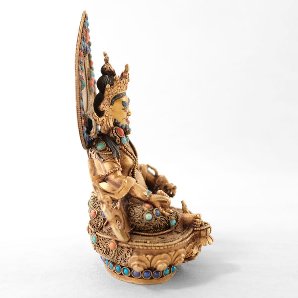Jambhala statue, body from copper, lost wax casting, decorated with fine filigree, gold and silver plated, set with turquoise, coral and lapis lazuli. The face is set in gold. Handmade in Nepal