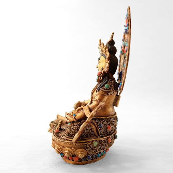 Jambhala statue, body from copper, lost wax casting, decorated with fine filigree, gold and silver plated, set with turquoise, coral and lapis lazuli. The face is set in gold. Handmade in Nepal