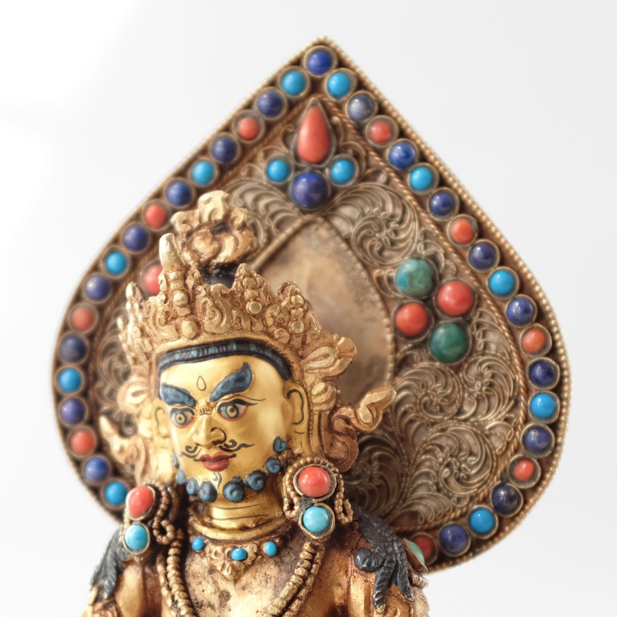 Jambhala statue, body from copper, lost wax casting, decorated with fine filigree, gold and silver plated, set with turquoise, coral and lapis lazuli. The face is set in gold. Handmade in Nepal