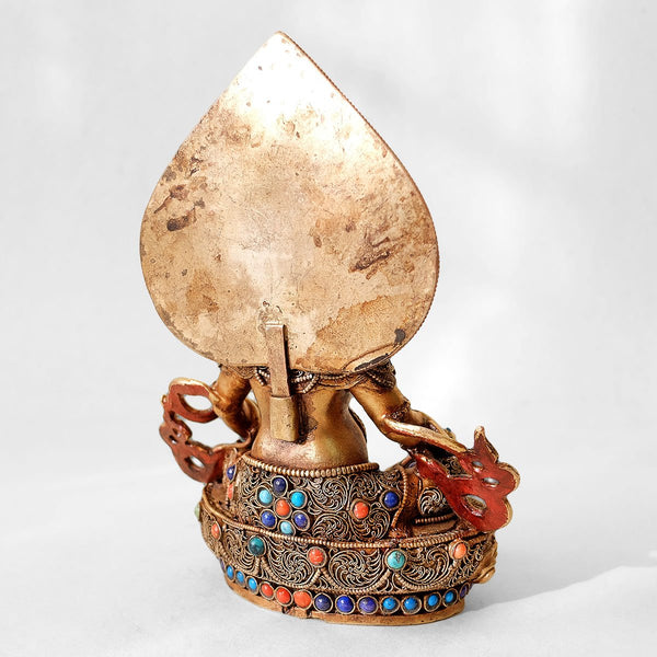 Jambhala statue, body from copper, lost wax casting, decorated with fine filigree, gold and silver plated, set with turquoise, coral and lapis lazuli. Backside view. Handmade in Nepal