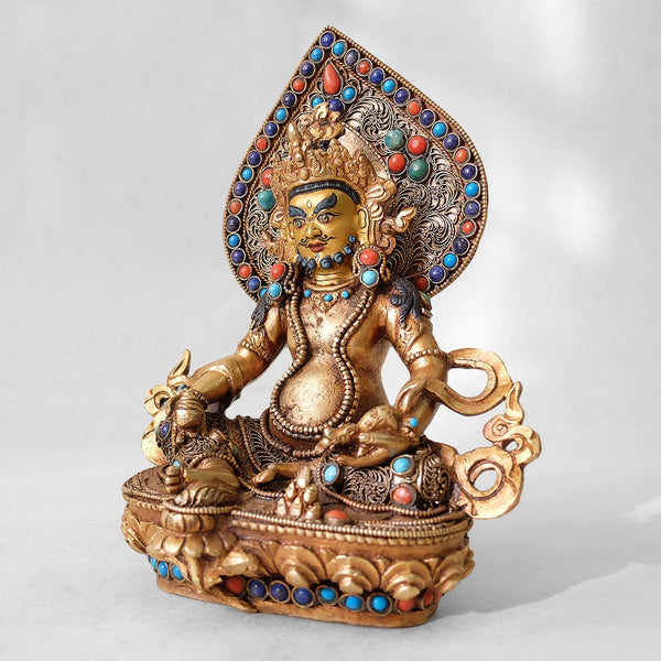 Jambhala statue, body from copper, lost wax casting, decorated with fine filigree, gold and silver plated, set with turquoise, coral and lapis lazuli. The face is set in gold. Handmade in Nepal