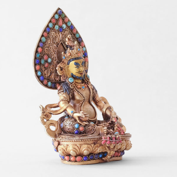 Jambhala statue, body from copper, lost wax casting, decorated with fine filigree, gold and silver plated, set with turquoise, coral and lapis lazuli. The face is set in gold. Handmade in Nepal