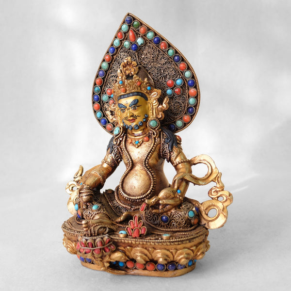 Jambhala statue, body from copper, lost wax casting, decorated with fine filigree, gold and silver plated, set with turquoise, coral and lapis lazuli. The face is set in gold. Handmade in Nepal