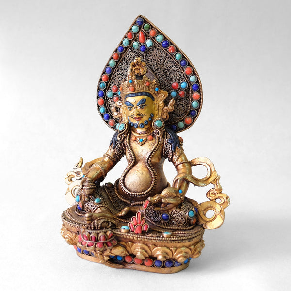 Jambhala statue, body from copper, lost wax casting, decorated with fine filigree, gold and silver plated, set with turquoise, coral and lapis lazuli. The face is set in gold. Handmade in Nepal