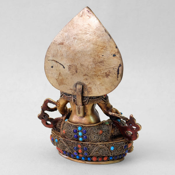 Jambhala statue, body from copper, lost wax casting, decorated with fine filigree, gold and silver plated, set with turquoise, coral and lapis lazuli. Backside view. Handmade in Nepal