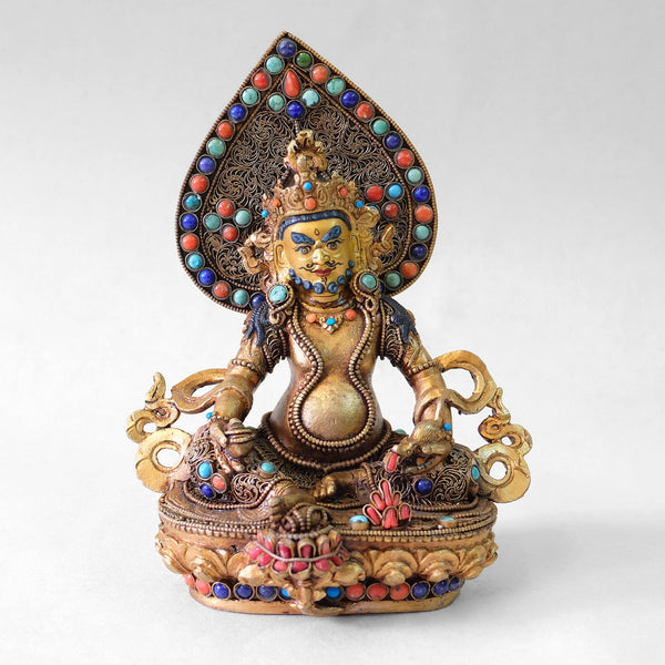 Jambhala statue, body from copper, lost wax casting, decorated with fine filigree, gold and silver plated, set with turquoise, coral and lapis lazuli. The face is set in gold. Handmade in Nepal