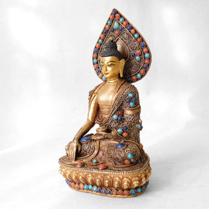 Shankyamuni Buddha statue, body from copper, lost wax casting, decorated with fine filigree, gold and silver plated, set with turquoise, coral and lapis lazuli. The face is set in gold. Handmade in Nepal