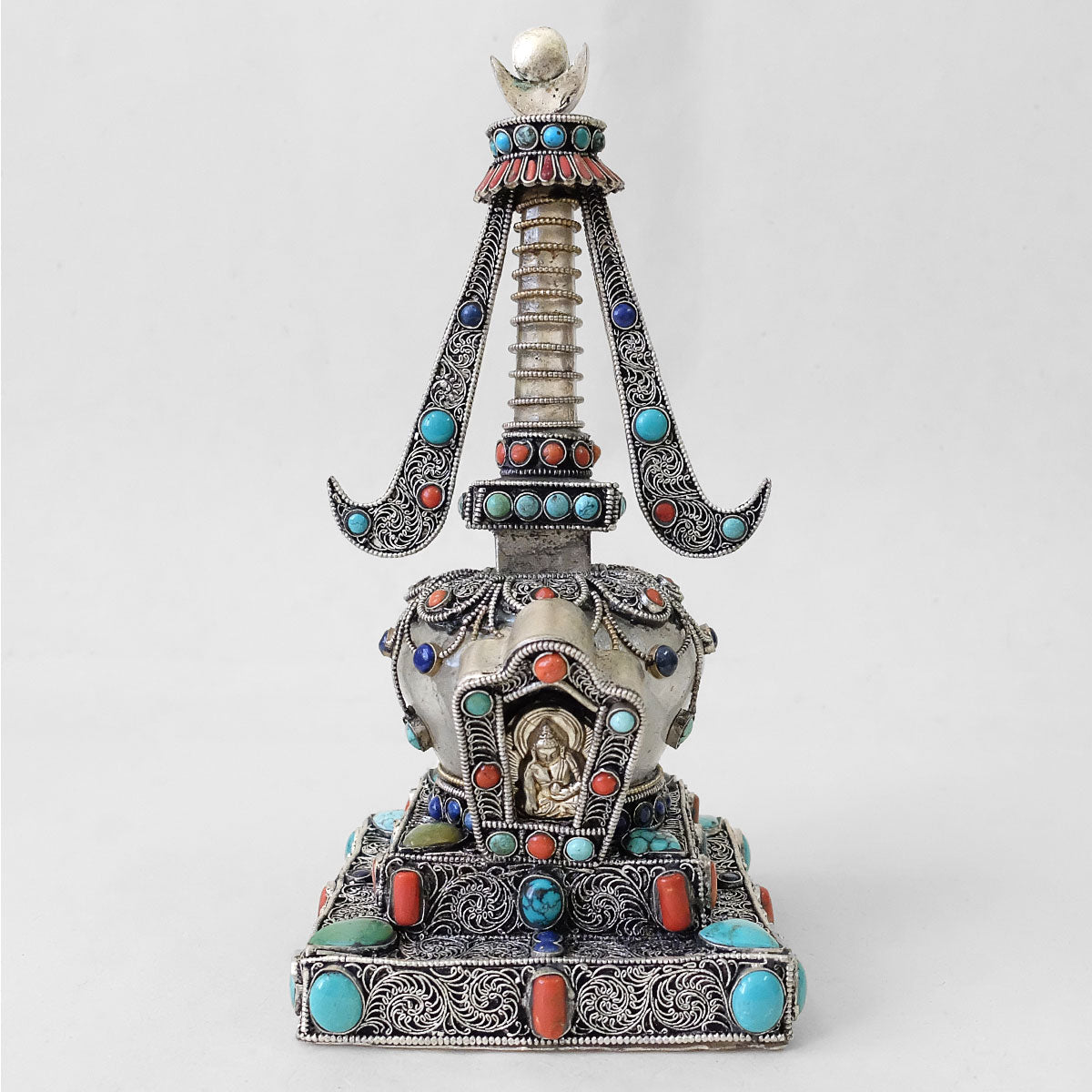 Front view, small stupa made of crystal and copper. Decorated with filigree. Silver plated. Set with coral, lapis lazuli and turquoise. Made by Shanta Shakya