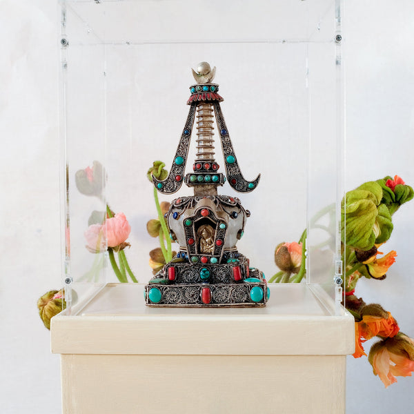 Small stupa made of crystal and copper. Decorated with filigree. Silver plated. Set with coral, lapis lazuli and turquoise.